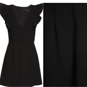 Black, flirty dress. finished with ruffles.

• 34" length
• V-neck
• Lined